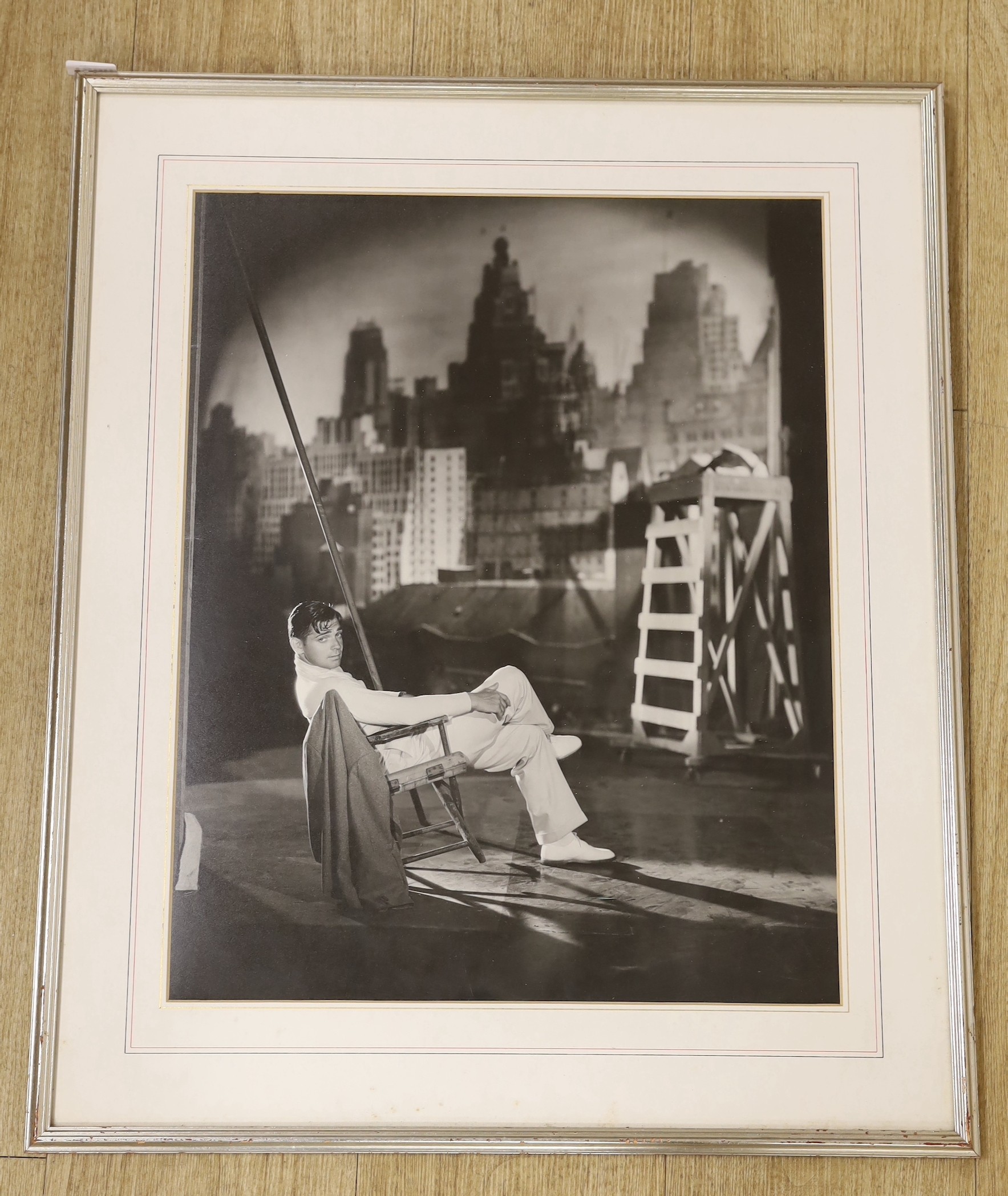 George Hurrell (photographer 1904-1992), photograph, Clark Gable reclining on a chair on a New York roof top, dated 1931, 50 x 40cm